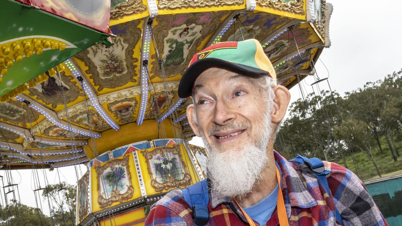 Photographer Robert Brown explores sideshow alley on day 3 of the Toowoomba Royal Show. Sunday, March 27, 2022. Picture: Nev Madsen.