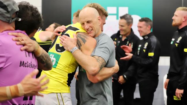 Greg 'Clanger' Kleynjans embraces Richmond Tigers defender Nathan Broad after the 2020 Preliminary Final victory over Port Power.