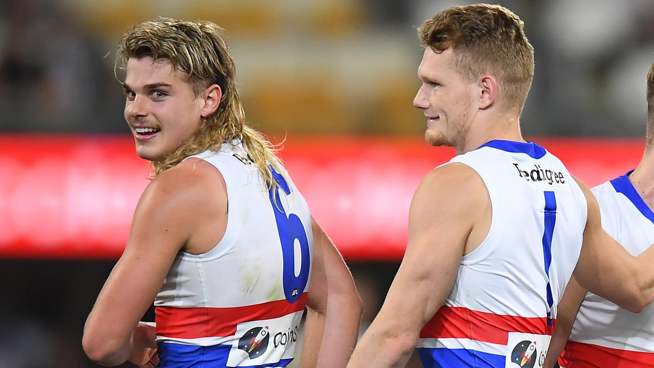 BRISBANE, AUSTRALIA - SEPTEMBER 04: Western Bulldogs players (L-R) Bailey Smith, Lachie Hunter and Adam Treloar celebrate victory during the AFL 1st Semi Final match between the Brisbane Lions and the Western Bulldogs at The Gabba on September 04, 2021 in Brisbane, Australia. (Photo by Albert Perez/AFL Photos via Getty Images)