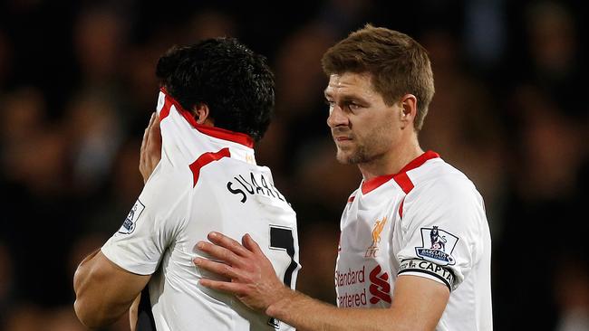 Liverpool's English midfielder Steven Gerrard consoles Luis Suarez.