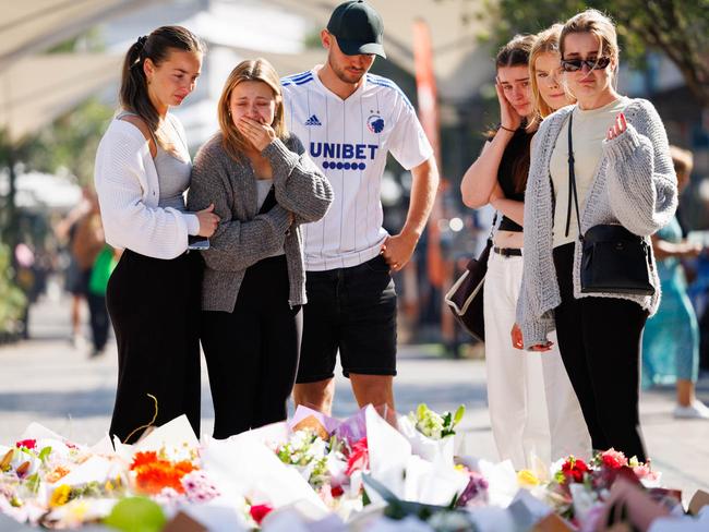 Members of the public laying flowers outside Westfield Bondi Junction. Picture: NCA NewsWire / David Swift