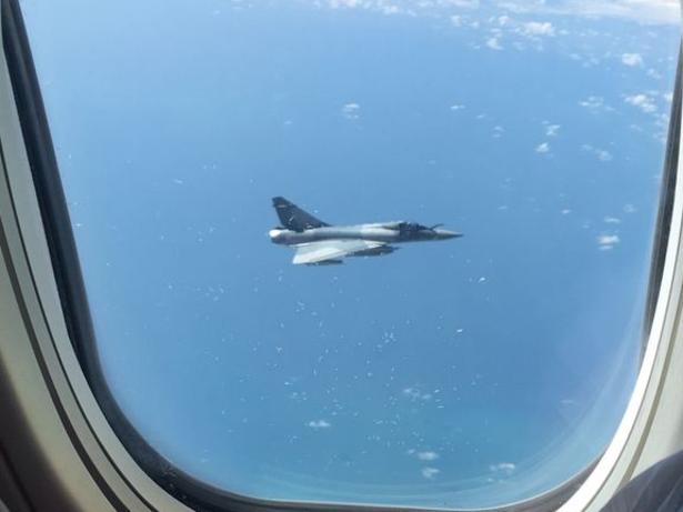 Passenger Emily Hatfield snapped this photo of a fighter jet shadowing the flight