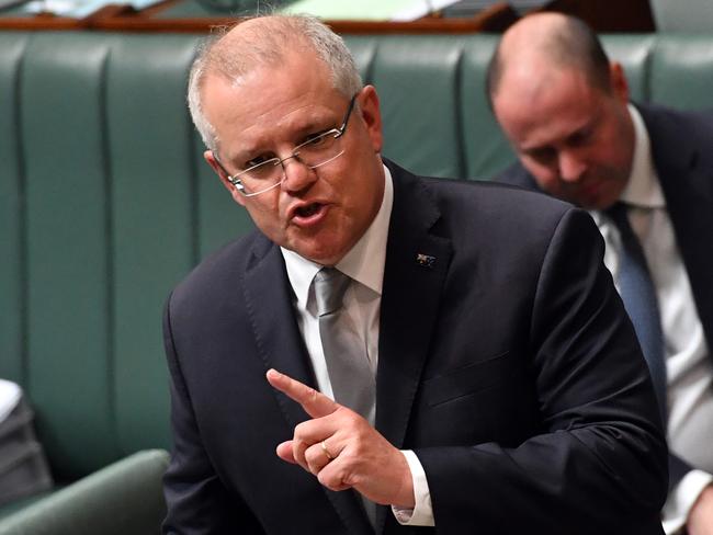 CANBERRA, AUSTRALIA - MAY 13: Prime Minister Scott Morrison speaks at the despatch box during Question Time in the House of Representatives at Parliament House on May 13, 2020 in Canberra, Australia. Parliament will resume for three days this week but is otherwise adjourned until August.  Australian states are now beginning to lift COVID-19 measures with national cabinet mapping out a three-stage program to help the economy return to normal, Treasury estimates it would cost NSW and Victoria $2.4 billion a week combined in lost economic activity if the states had to re-impose the restrictions it started loosening. Treasurer Josh Frydenberg is facing the largest budget deficit in Australian fiscal history with Deloitte Access Economics predicting it could reach $143 billion this year and $131.6 billion in 2020-21 financial year as the economy slumps due to measures aimed at stopping the spread of the COVID-19 pandemic. (Photo by Sam Mooy/Getty Images)