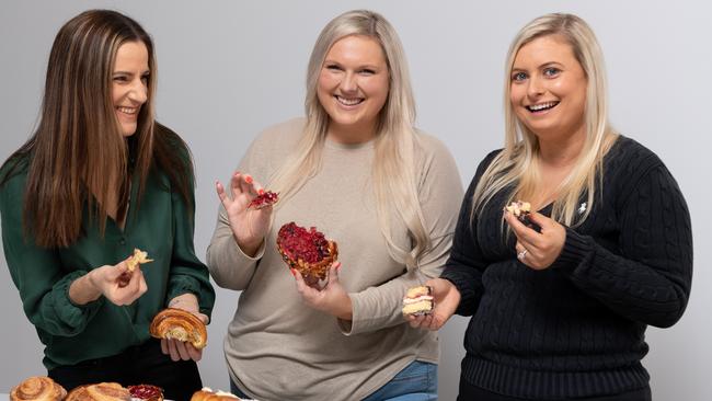 Sarah Sackville, Ally Bareham and Elly Wakefield tuck into some pastries. Picture: Monique Harmer