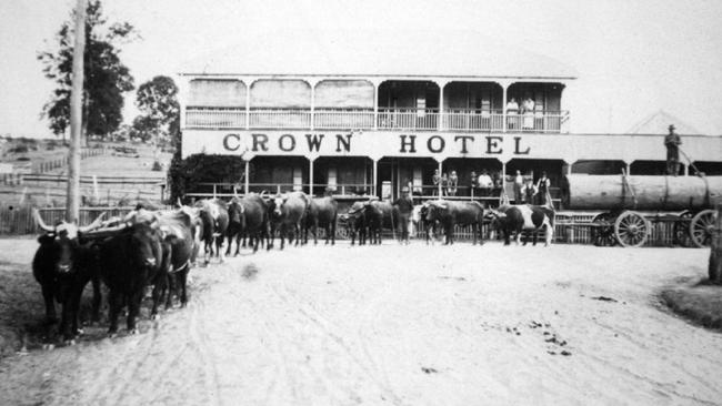 Sam Heathwood's bullock team carting timber through Dayboro, early 1920s. The team is passing in front of the Crown Hotel (built 1913 near the site of an earlier building /licensed from /1892) and turning into Williams Street. The massive log was removed from land held by the French family in the /Mount /Pleasant area. logging industry qld  transport  history