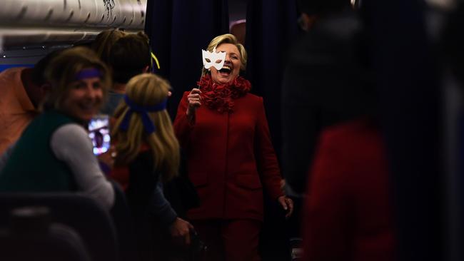 ‘There is no case here’: Hillary Clinton lifts the mask on her campaign plane at Erlanger, Kentucky.