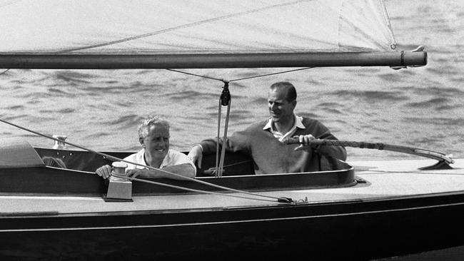 Prince Philip takes the tiller of his yacht <i>Bluebottle</i> before competing with his friend Uffa Fox at the 1960 Cowes sailing regatta. Actress Joanna Lumley – who has known Philip for years has talked up his action man credentials, saying he could have been James Bond. “I think he’s just an extraordinary character, he rides, sails, drives horses, fishes, swims,” she said. “He really could have been Bond and he was a naval commander as well like Commander Bond.” Picture: AP