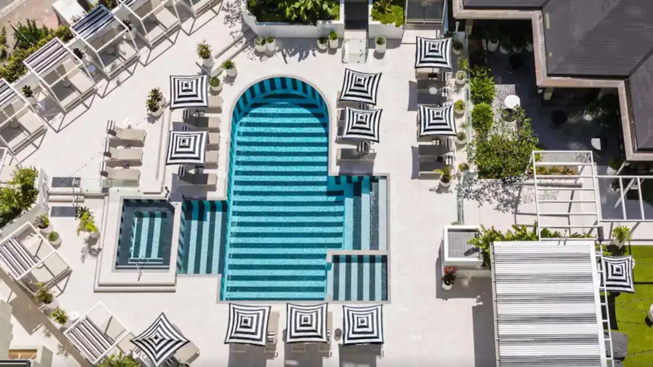 The QT hotel has a lush pool to enjoy.