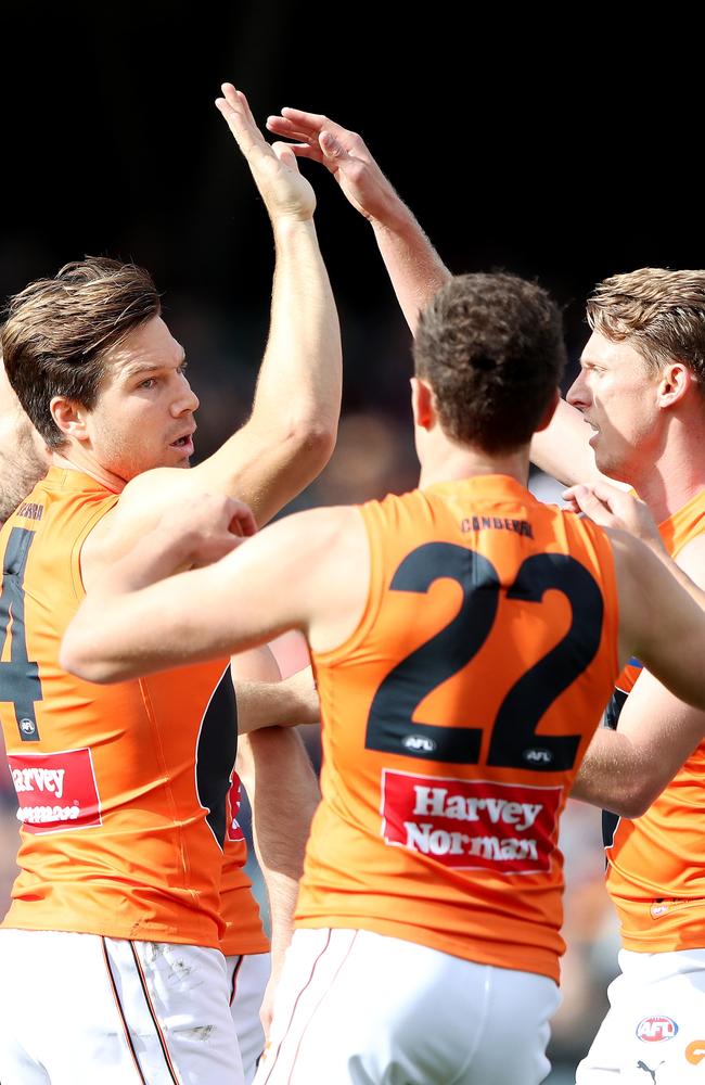 Toby Greene of the Giants celebrates a goal with Josh Kelly and Lachie Whitfield during the 2022 AFL Round 07 match between the Adelaide Crows and the GWS Giants at Adelaide Oval on April 30, 2022 in Adelaide, Australia. (Photo by Sarah Reed/AFL Photos via Getty Images)