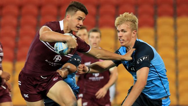 Jack Howarth pushes off his New South Wales opponent duirng the U-18 Origin match at SunCorp Stadium. Picture: Adam Head