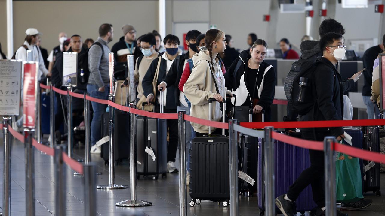 Travellers queue up to check in at Sydney Airport’s T2 domestic terminal. Picture: John Appleyard