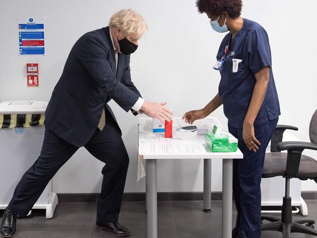 Boris Johnson uses hand sanitiser at Chase Farm Hospital in north London as Britain's NHS ramps up its rollout of the newly approved AstraZeneca/Oxford COVID-19 vaccine. Picture: AFP