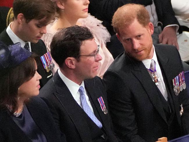 Prince Harry could be seen telling Princess Eugenie’s husband Jack Brooksbank he was “heading off”. Picture: AFP