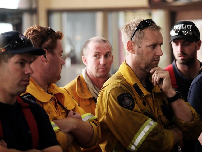 Remote area fire fighter Luke Mellers (hand on chin) listens to morning briefing at Geeveston fire station. Picture: LUKE BOWDEN