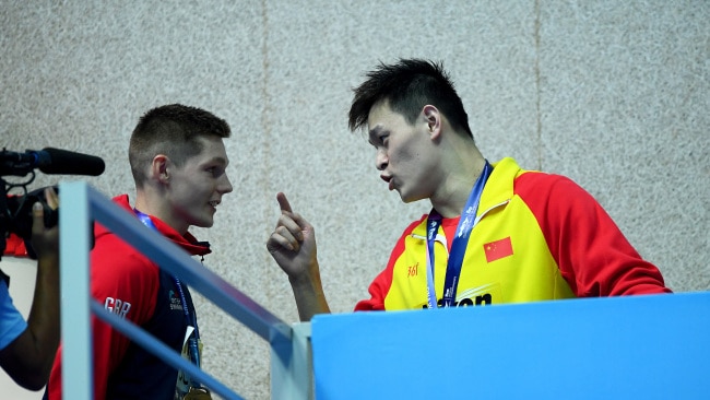 Sun Yang (right) yelled "you're a loser, I'm a winner" at Duncan Scott after he refused to pose for a photo with the Chinese swimmer. Picture: Quinn Rooney/Getty Images