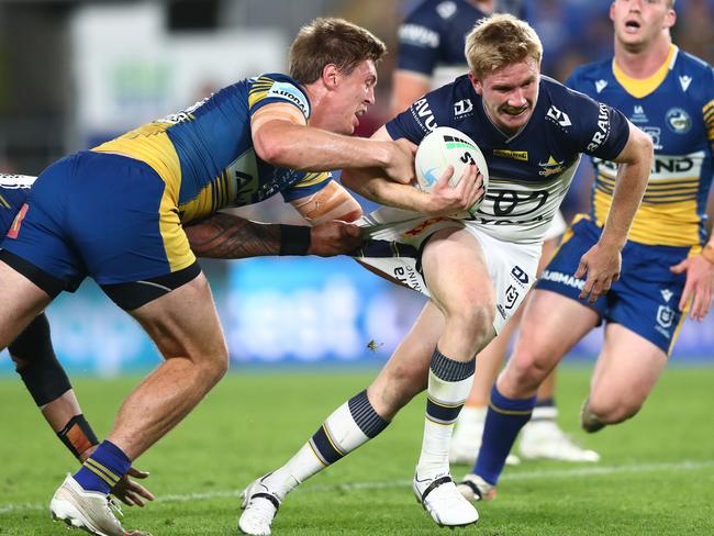 Tom Dearden of the Cowboys is tackled during the round 23 NRL match between the Parramatta Eels and the North Queensland Cowboys at Cbus Super Stadium. (Photo by Chris Hyde/Getty Images)