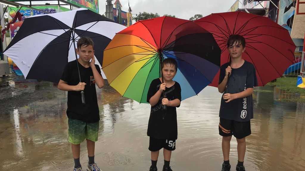 Zac Montgomery, Ashton Northey and Tristan Northey enjoying wet weather at the Heritage Bank Toowoomba Royal Show 2017.