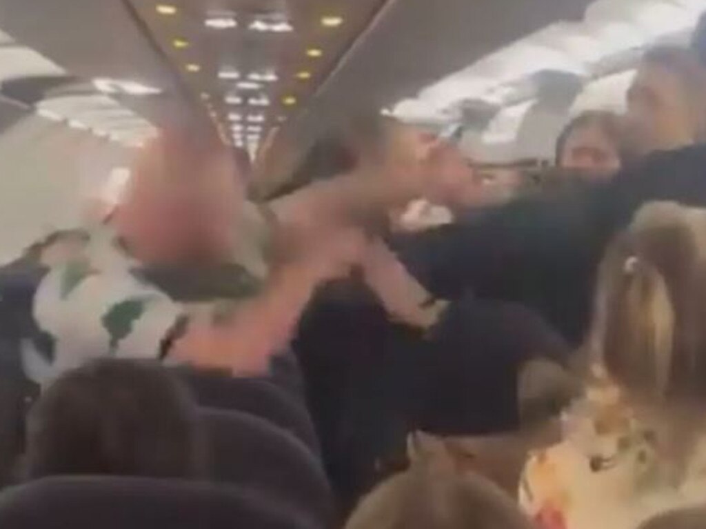 Video shows the man in the green and white striped shirt throwing punches before falling to the floor.