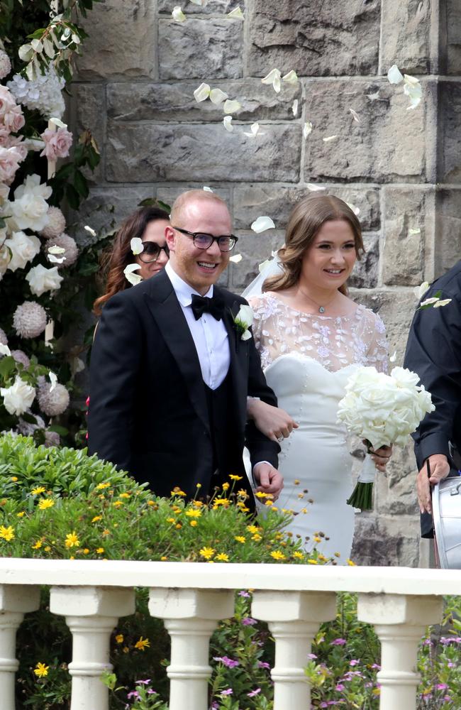 Nassib Thoumi and Paula Pratt walk out of church after their wedding.