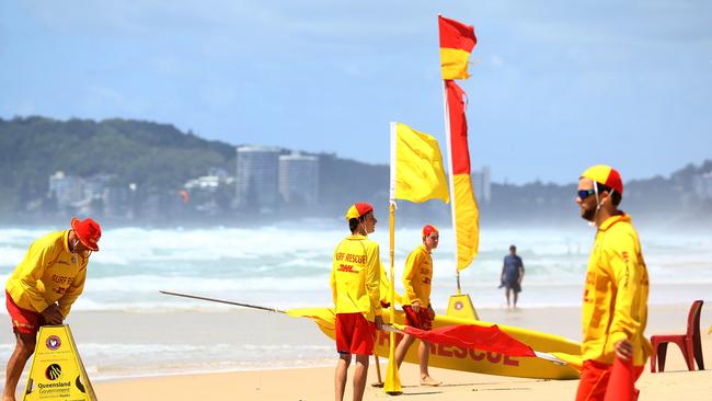 Lifesavers from Mermaid Beach adjust the position of the flags due to changing surf conditions Pic by David Clark.