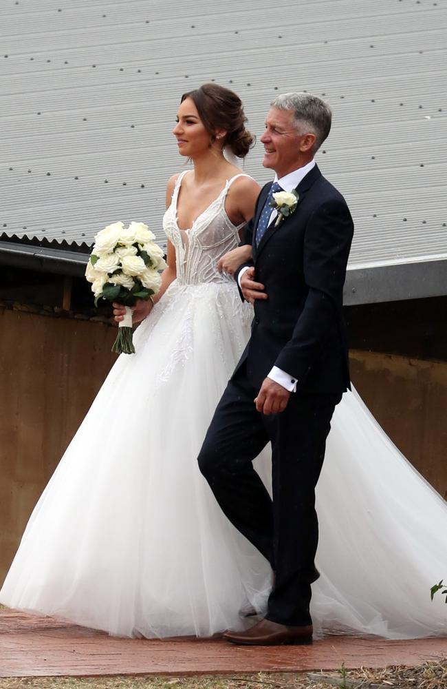 Teigan Power walks down the aisle with her father. Picture:  Diimex