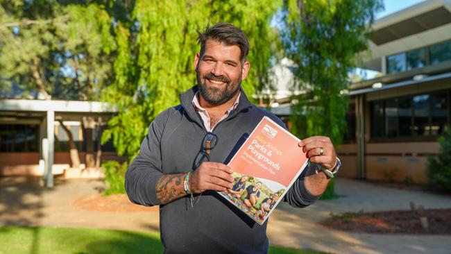 Alice Springs Town Council Mayor Matt Paterson holds the council's latest parks and playgrounds implementation plan. Picture: Alice Springs Town Council