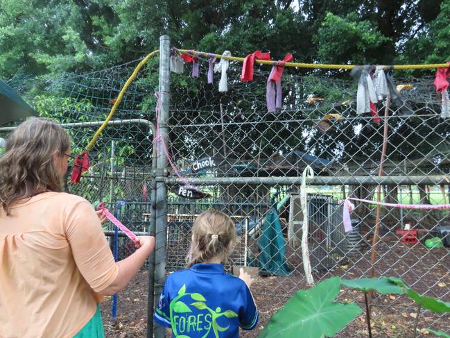 Students wrote tributes on ribbons and attached them to the chook pen at Jingili Primary School after 10 of their chickens were killed in February. Picture: Bethany Griffiths