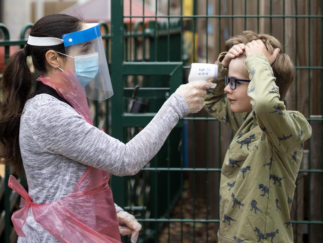 A member of staff wearing personal protective equipment takes a child's temperature at the Harris Academy's Shortland's school in London. Picture: Dan Kitwood