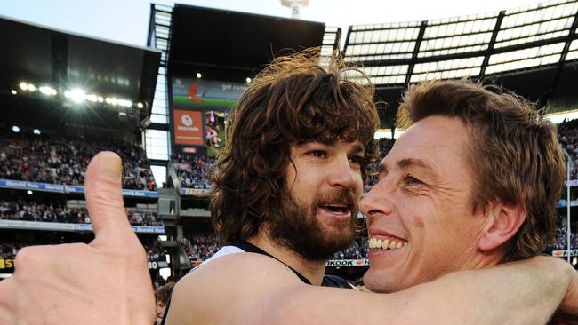 Cats coach Mark Thompson is embraced by Max Rooke after winning the 2009 grand final.