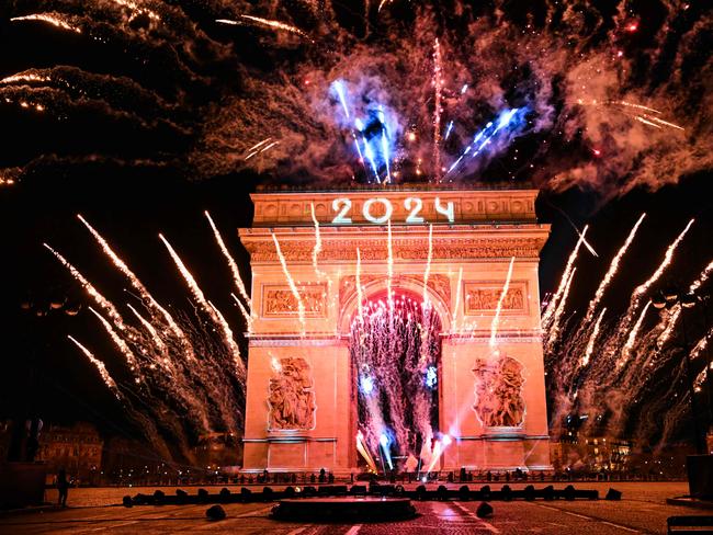 Fireworks explode next to the Arc de Triomphe with 2024 projected, at the Avenue des Champs-Elysees during New Year celebrations in Paris. Picture: AFP