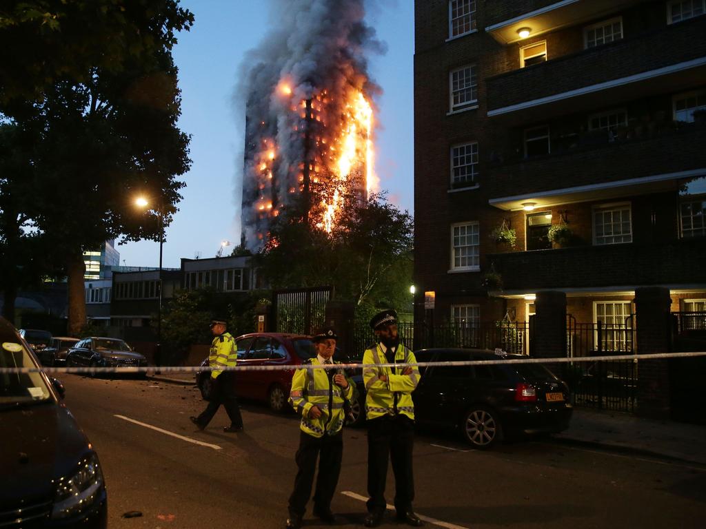 Police enforce a security cordon around the Grenfell Tower as firefighters battle the huge blaze and emergency services treat “a number of people for a range of injuries”, including smoke inhalation. Picture: AFP Photo/Daniel Leal-Olivas