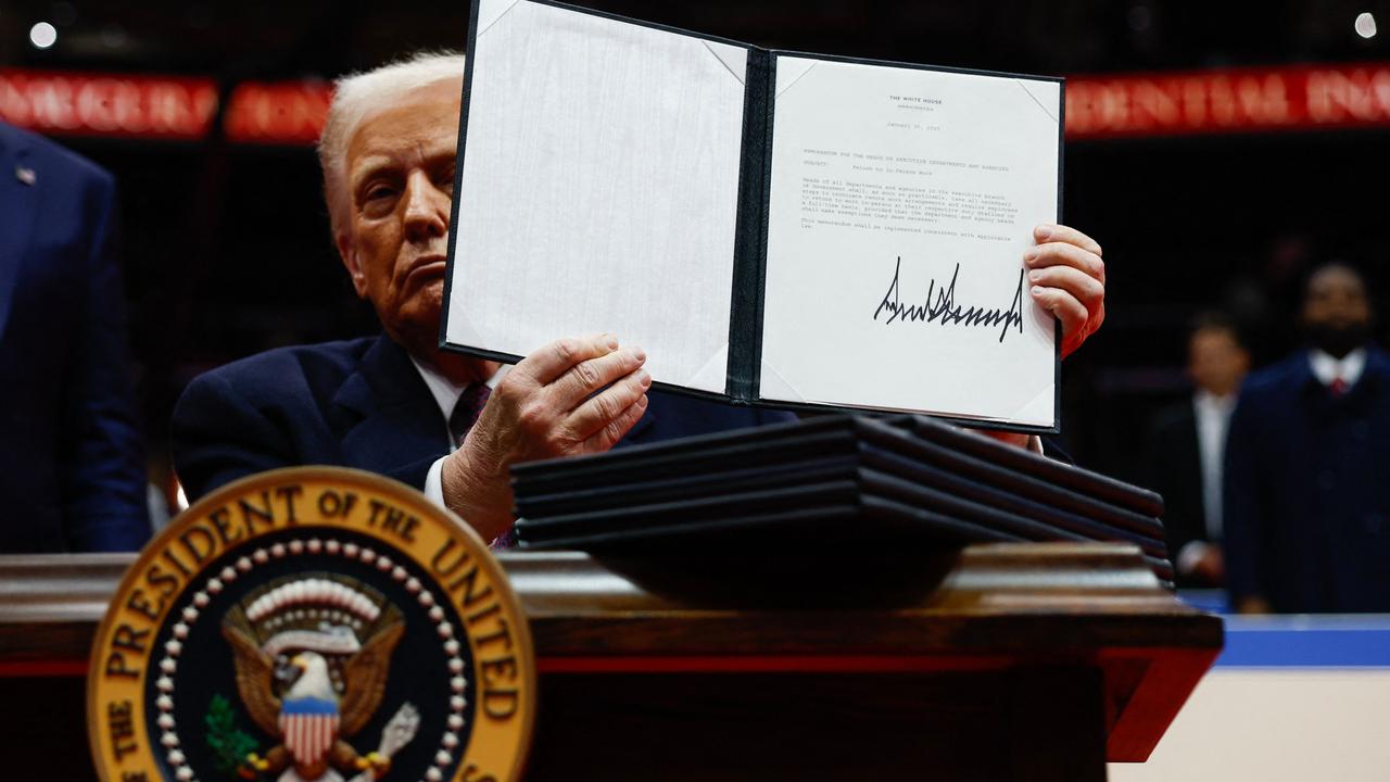 Donald Trump holds up an executive order after signing it during an indoor inauguration parade at Capital One Arena on January 20, 2025. Picture: Anna Moneymaker/Getty Images/AFP