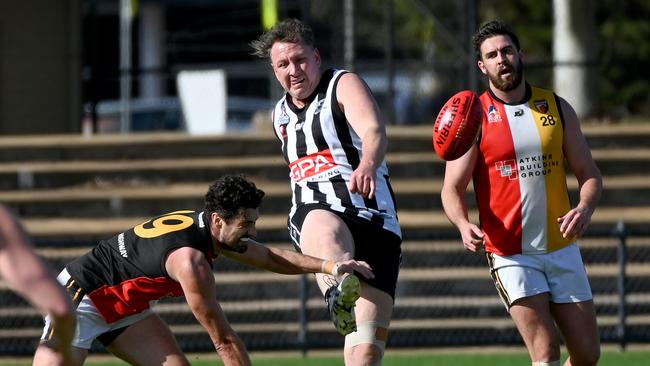 PNU’s Sam Baulderstone kicks away. The ruckman was a dominant force for the Falcons in the middle. Picture: Naomi Jellicoe