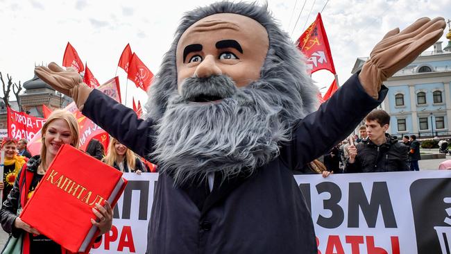 A demonstrator dressed as Karl Marx marches along with activists and supporters of Russia's left-wing parties and movements during a May Day rally.