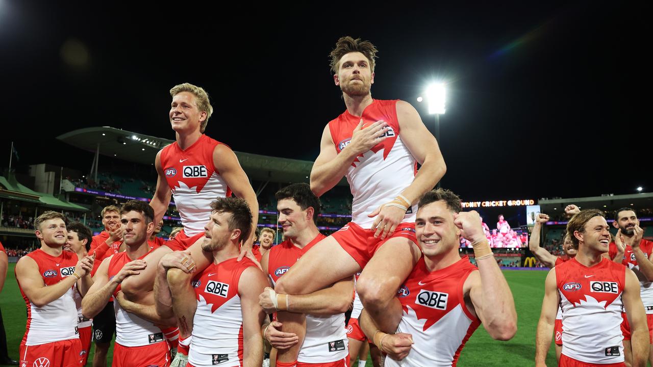 Isaac Heeney and Dane Rampe of the Swans are chaired off after their milestone matches. Picture: Matt King/AFL Photos/Getty Images