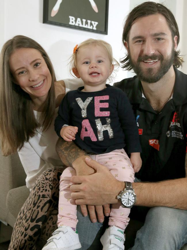 Former West Adelaide defender Adam Hartlett with his wife Sarah and then 17-month-old daughter Indi. Picture: AAP/Dean Martin