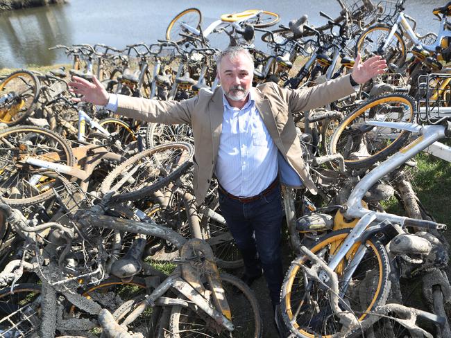 Yarra Riverkeeper Andrew Kelly with dozens of oBikes fished out of the Yarra. Picture: David Crosling