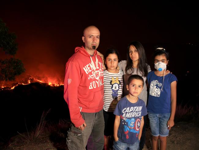 The Ayoub famil: Father Paul, Tara, 10, mother Manal, Liana, 12, and PJ, 6 stand across the road from their home on Royal Oak Ave in Alfords Point. Picture: Damian Shaw