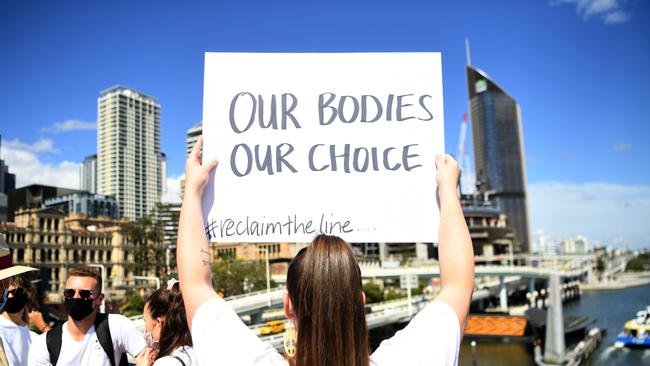 Protesters march across Victoria Bridge, Brisbane during a rally against a mandatory Covid-19 vaccine. (Photo by Dan Peled/Getty Images)