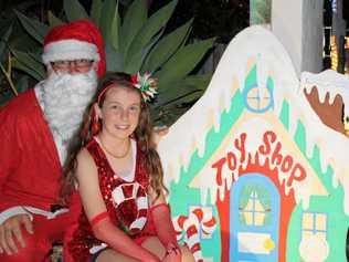 CHRISTMAS FUN: Santa (aka Damian Langdon) and Gypsy Russell, 11, at the Leith Place Christmas lights. Picture: Michele Sternberg