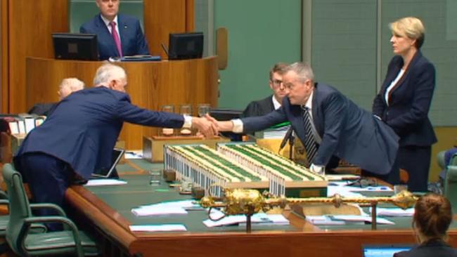 Malcolm Turnbull and Opposition Leader Bill Shorten shake hands during a moment of unity in parliament yesterday. Source: Nine News