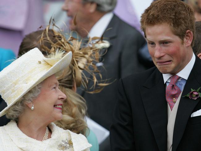 Queen Elizabeth II laughs with Prince Harry at Prince Charles and Camilla’s wedding in 2005. Picture: Supplied