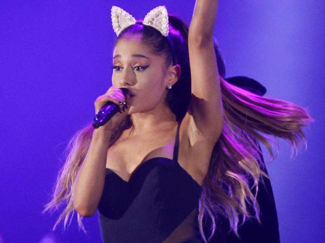 FILE - In this Aug. 26, 2015 file photo, Ariana Grande performs during the honeymoon tour concert in Jakarta, Indonesia. Grande's management team says the singer's concerts will be canceled through June 5, 2017, after a bombing following her concert in Manchester, England left 22 people dead. (AP Photo/Achmad Ibrahim, File)