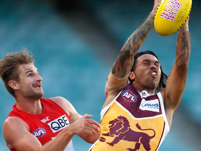 Allen Christensen flies in front of Swans defender Harry Marsh.