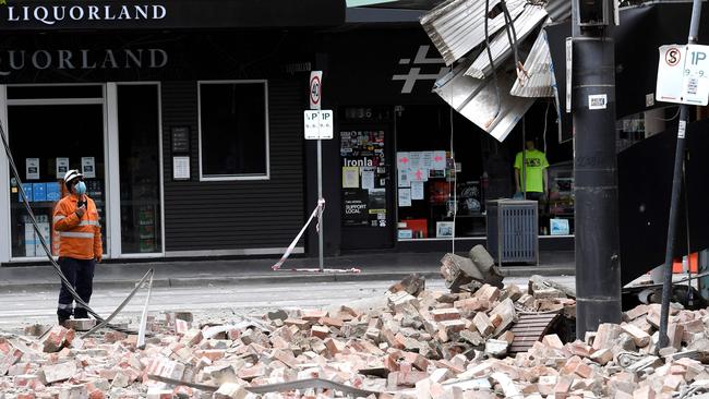 An emergency service and rescue official examining the damage to a building on Chapel St in Melbourne on September 22, 2021<span>. Picture: AFP</span>