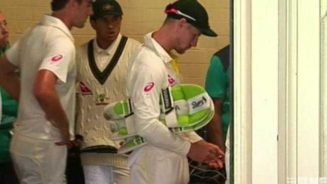 An image from a video purporting to show Cameron Bancroft taking sugar from a bowl and then placing it in his pocket during the Ashes. It was chewing gum.