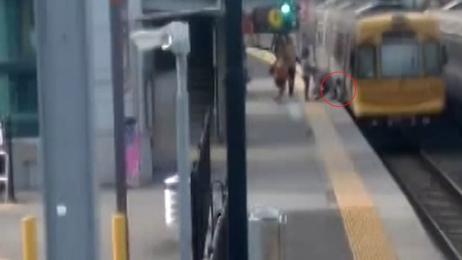 Footage of a toddler falling through the train tracks while their mum holds a pram at Alderley Station has been released. Picture: Queensland Rail.