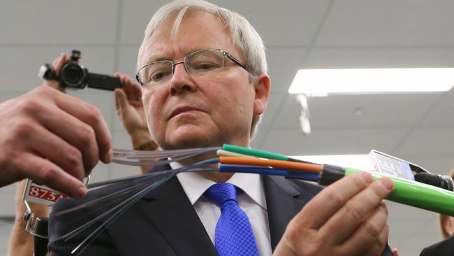 Former Prime Minister Kevin Rudd inspects green fibre optic cable used in the NBN rollout.