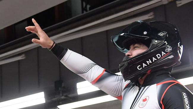 Aussie-turned-Canadian Chris Spring celebrates after heat two of the 2-man bobsleigh. Photo: AFP