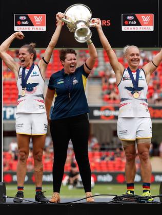 Chelsea Randall, Bec Goddard and Erin Phillips of the Crows hold the cup aloft after winning the inaugural AFLW Premiership in March. Picture: Michael Willson/AFL Media/Getty Images